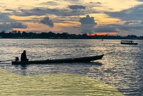 A person in a boat on the water. Sustainable Development - Inter-American Development Bank - IDB