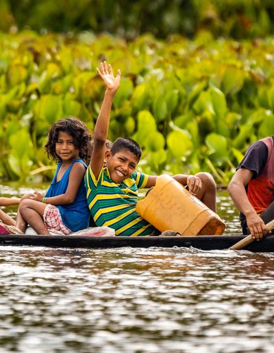 A group of people traveling by boat through the Amazon