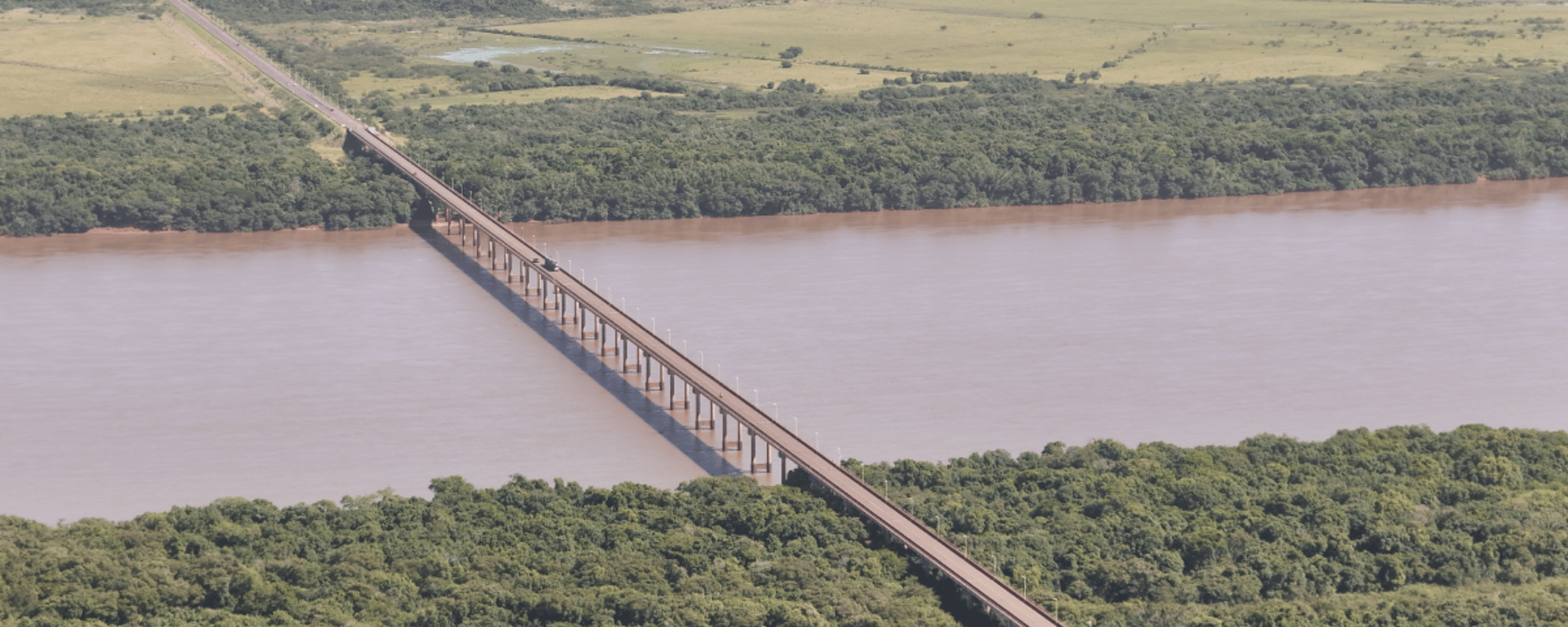 Aerial view of a bridge under a river, and a forest - Inter American Development Bank - IDB Invest