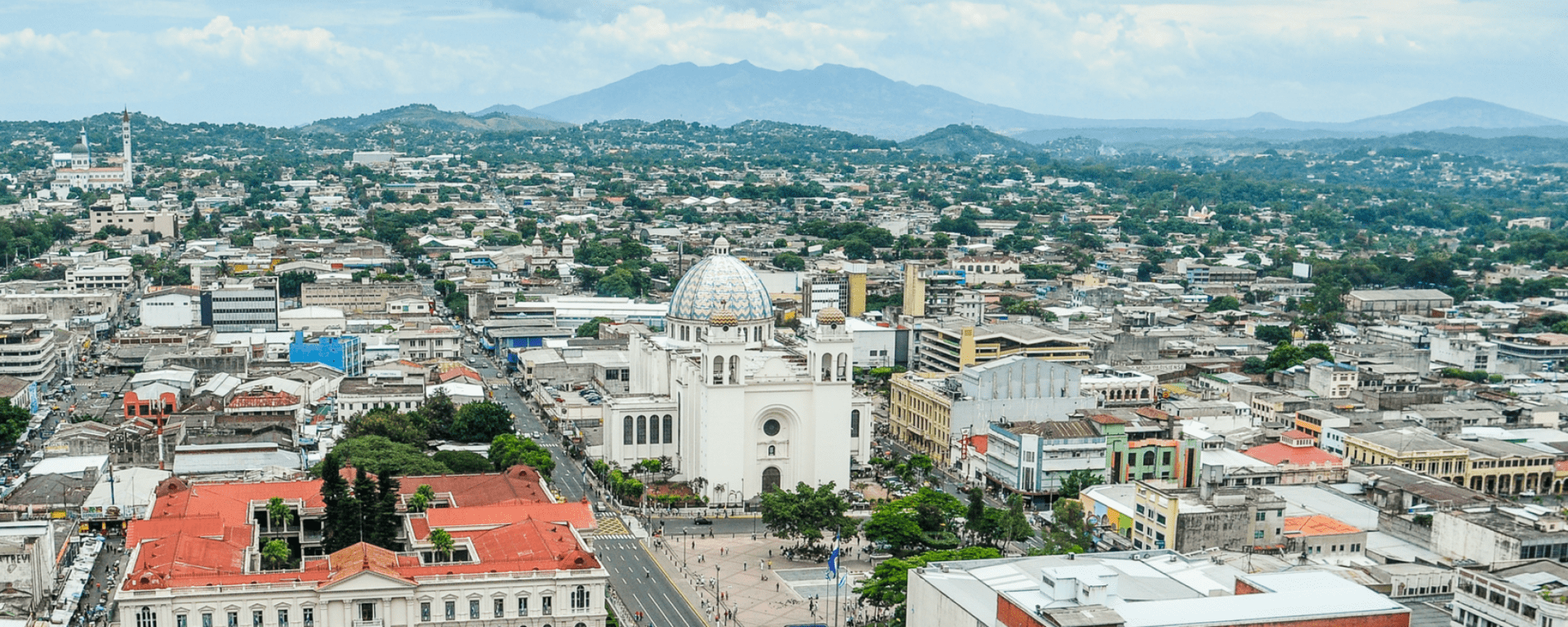 Panoramic day view of a small city with mountains on the horizon - Inter American Development Bank - Productivity Growth