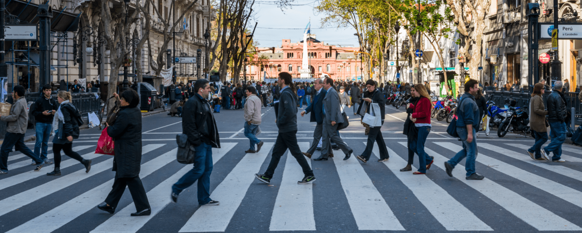 People walking on a crosswalk on a main city street- Inter American Development Bank - Alliance for Security, Justice and Development