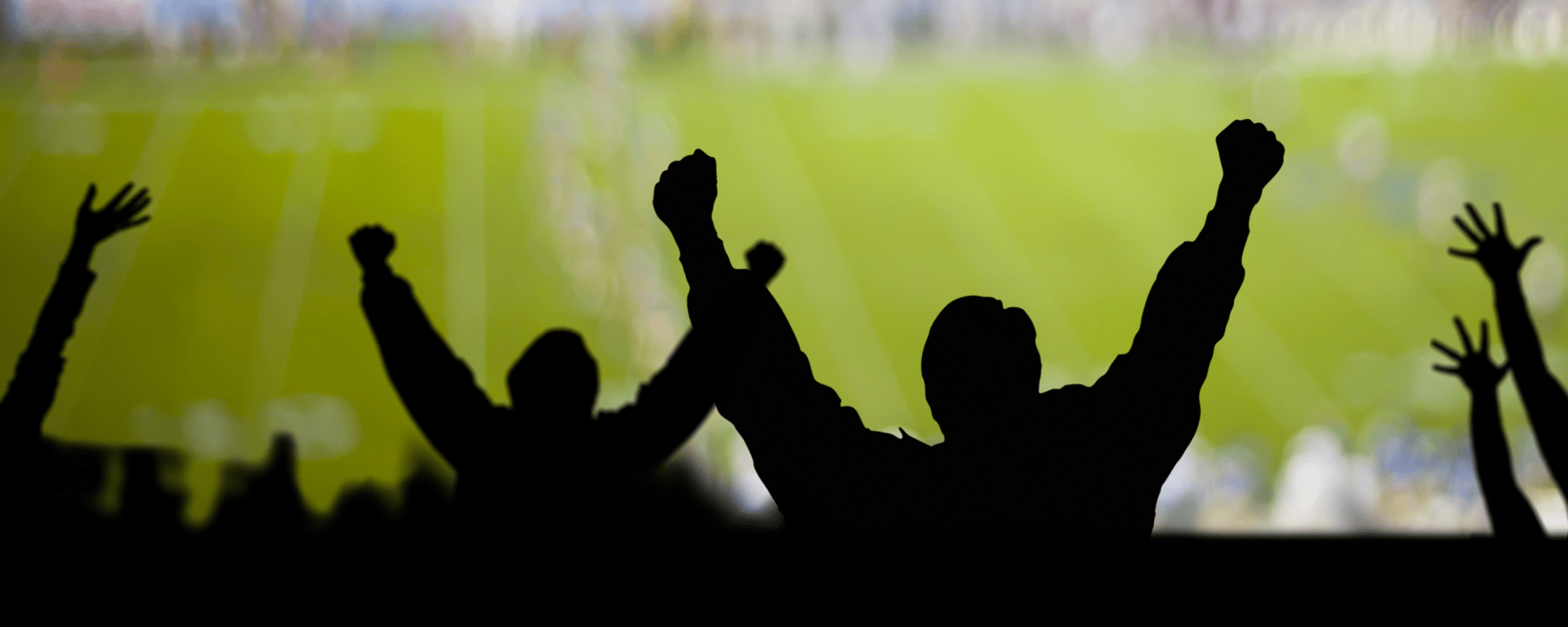People celebrating in front of a football screen - Inter American Development Bank - IDB