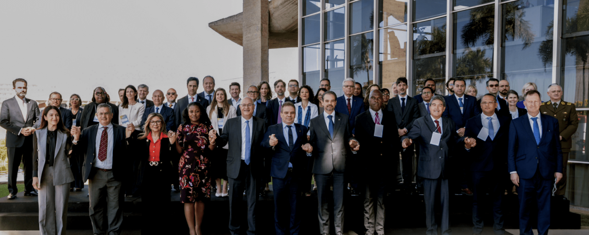 Executives standing outside a building - Inter American Development Bank - Citizen Security