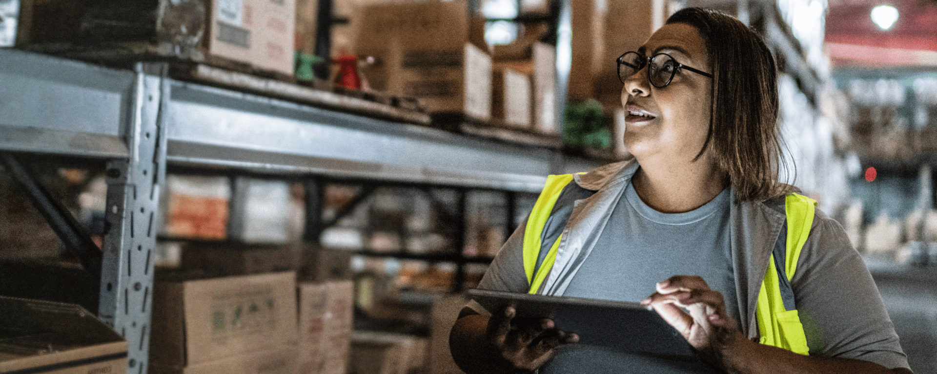 Person using a tablet in a warehouse IDB