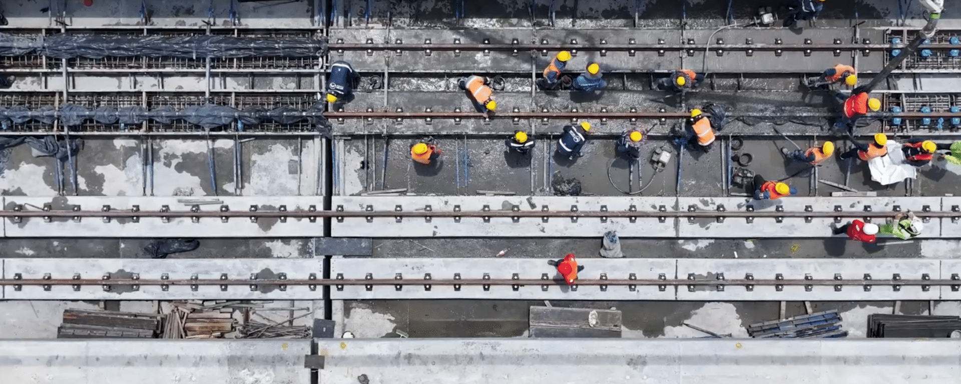 Aerial view of workers constructing urban rail transportation infrastructure IDB