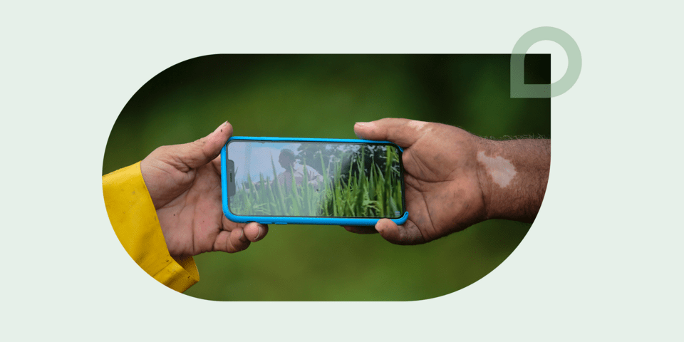 Mobile phone supported by two hands - Inter American Development Bank - IDB Development Impact