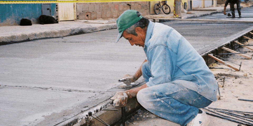 Man sitting on track under construction - Inter American Development Bank - IDB Natural Disaster