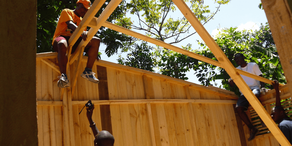 Black men working on a wooden house - Inter American Development Bank IDB - Climate and Change