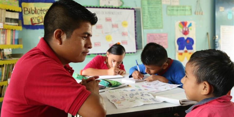Man and boy sitting in a classroom - Inter American Development Bank - Education