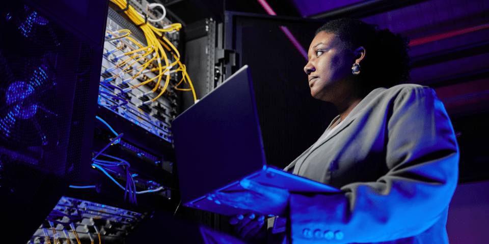 Afrodescendant woman holding a laptop computer - Inter American Development Bank - Cybersecurity