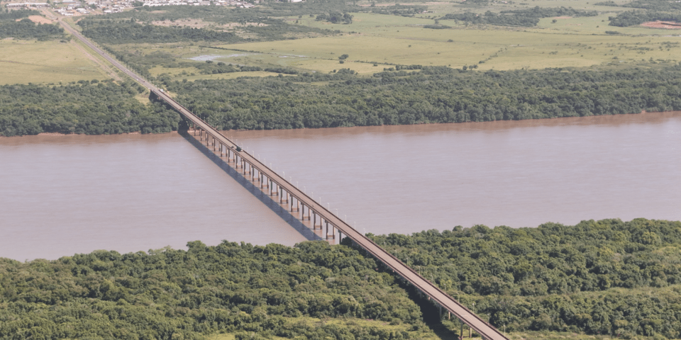 Aerial view of a bridge under a river, and a forest - Inter American Development Bank - IDB Invest
