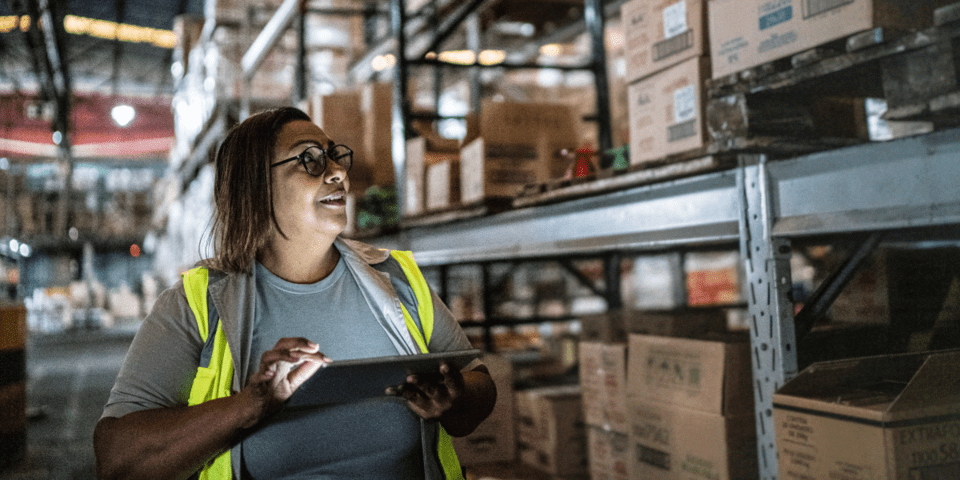 Person using a tablet in a warehouse IDB