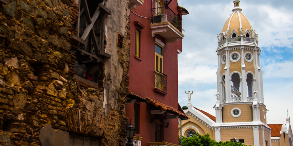A photo of an old city center, with a bell tower rising in the background, hinting at colonial architertural overtones