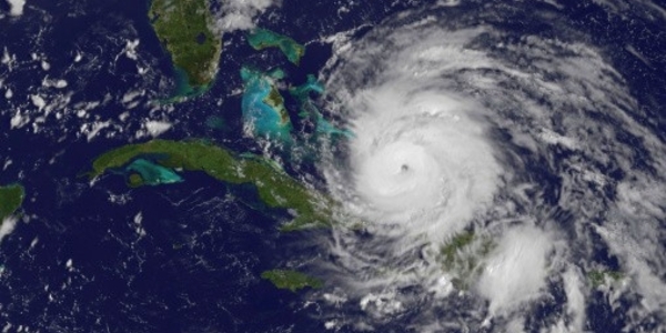 Satellite view of a hurricane over the Caribbean, with a well-defined eye and dense cloud bands.