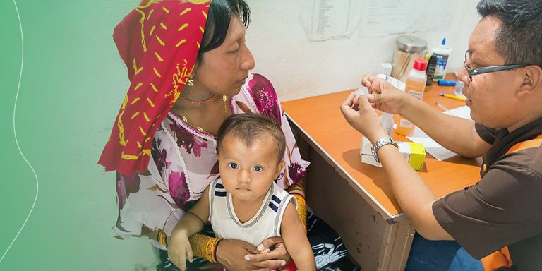 a person giving a baby a medicine