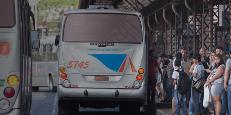 Public transportation terminal in Latin America with buses and people waiting in line, representing IDB-supported infrastructure projects aimed at improving urban mobility and access to services - Inter-American Development Bank - IDB - Results and Effectiveness