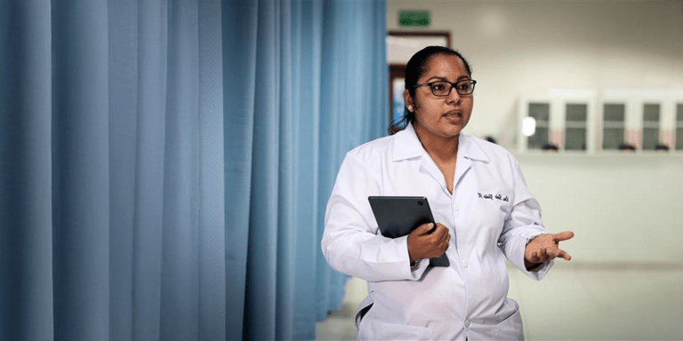 Female doctor talking in an ICU with her hand held - Inter American Development Bank - Impact Framework
