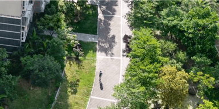 Aerial view of a modern building complex with green spaces, walking paths, and tree-lined park areas - Urban Development - IDB - Inter-American Development Bank
