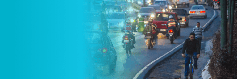 Night road with vehicles, motorcyclists and cyclists - Inter American Development Bank - Transport Infrastructure