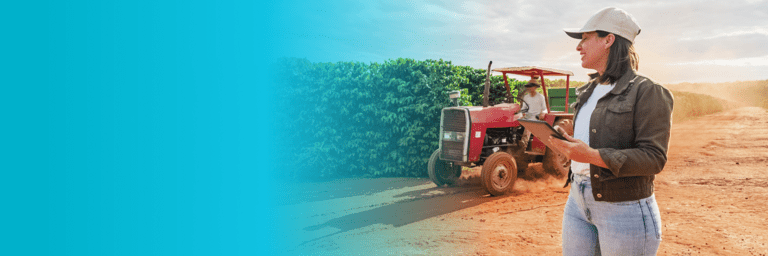 Woman holding her hands in front and a tractor in the background in front of a farm crop - Inter American Development Bank - Fiscal Management