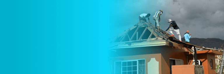 Men on the wooden roof of a house under construction - Inter American Development Bank - Disaster Management