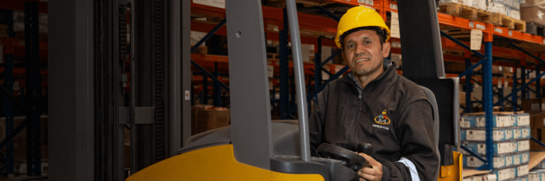 Man driving an electric vehicle in a warehouse - Inter American Development Bank - Research and Development