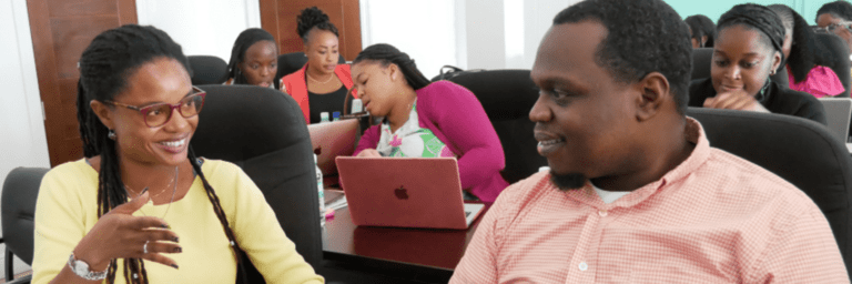 Afro descendant man smiling with a woman in a room - Inter American Development Bank - Education