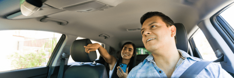 Driver smiling with a passenger - Inter American Development Bank - IDB