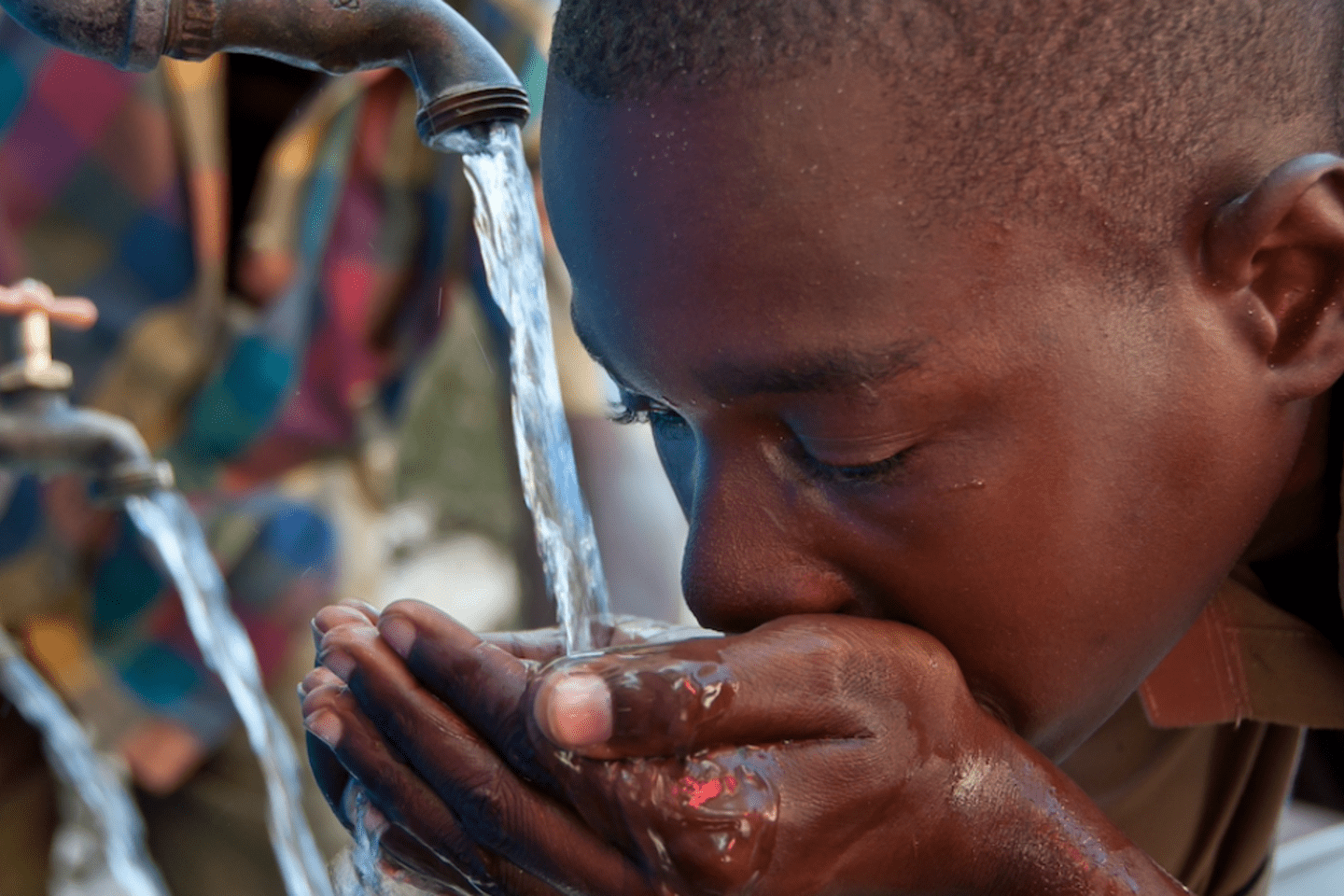 Young man drinking water - Inter American Development Bank - IDB