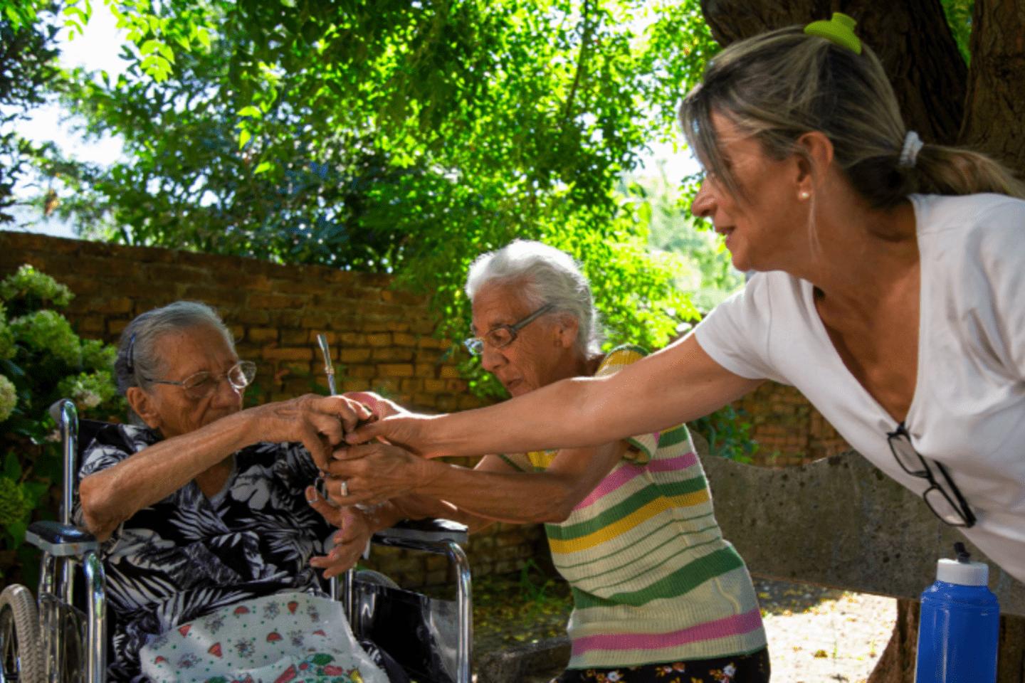 A woman in a wheelchair receives care.