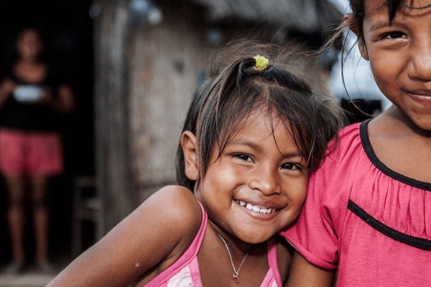 two young girls wearing pink shirts and smiling 
