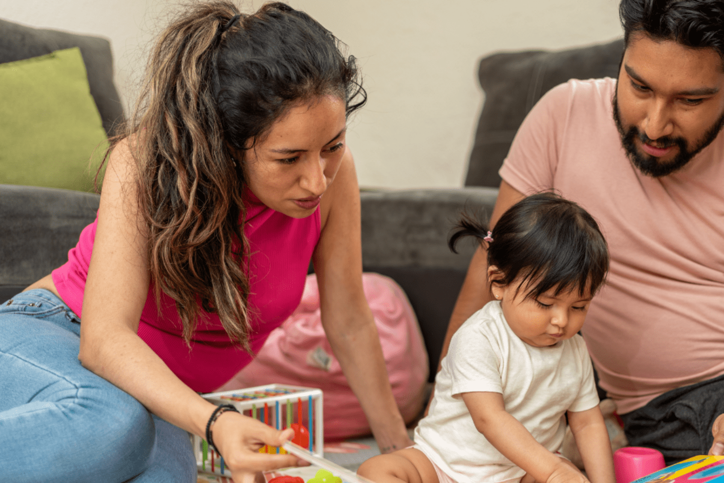 mother and father playing with their baby