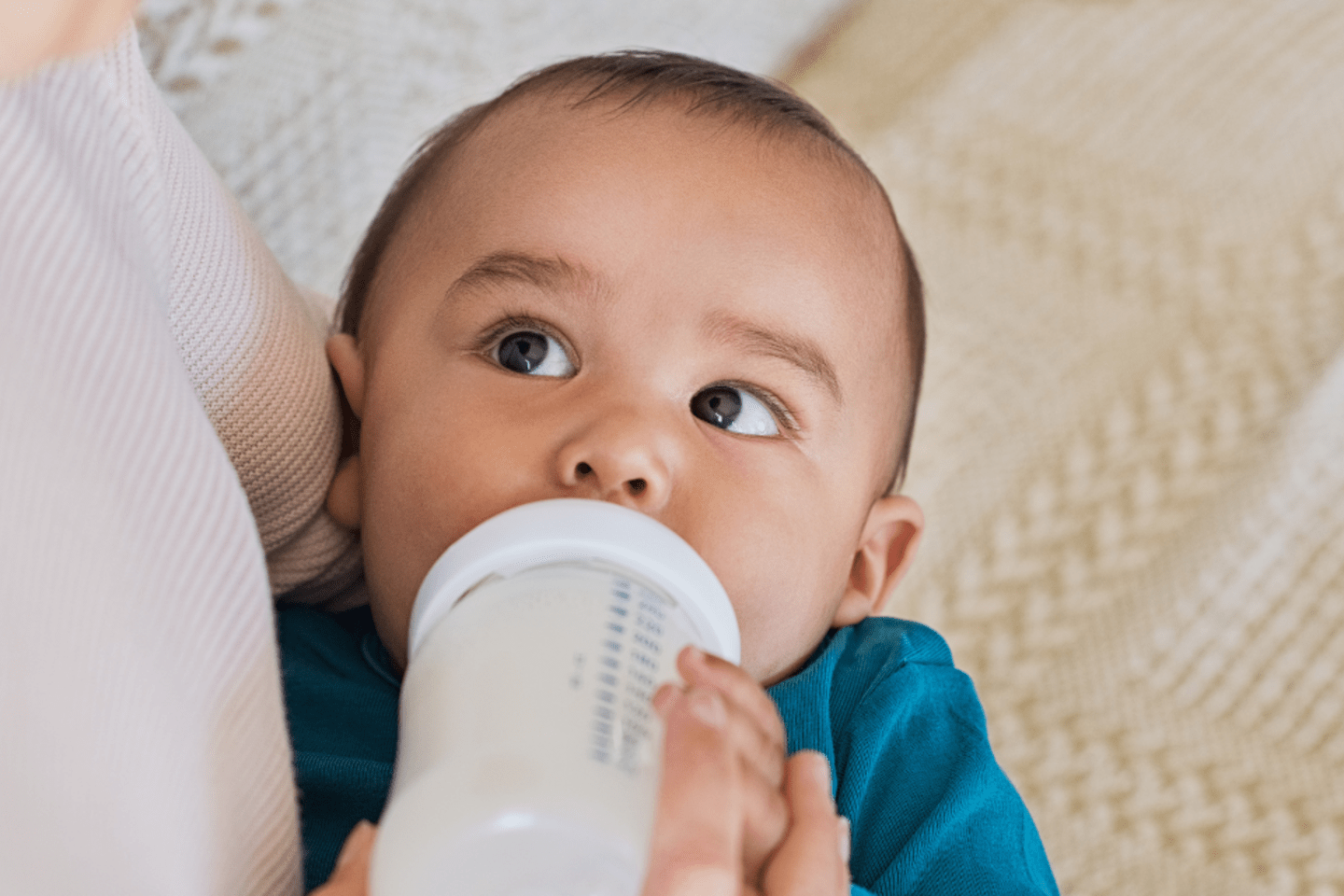baby drinking milk from bottle 