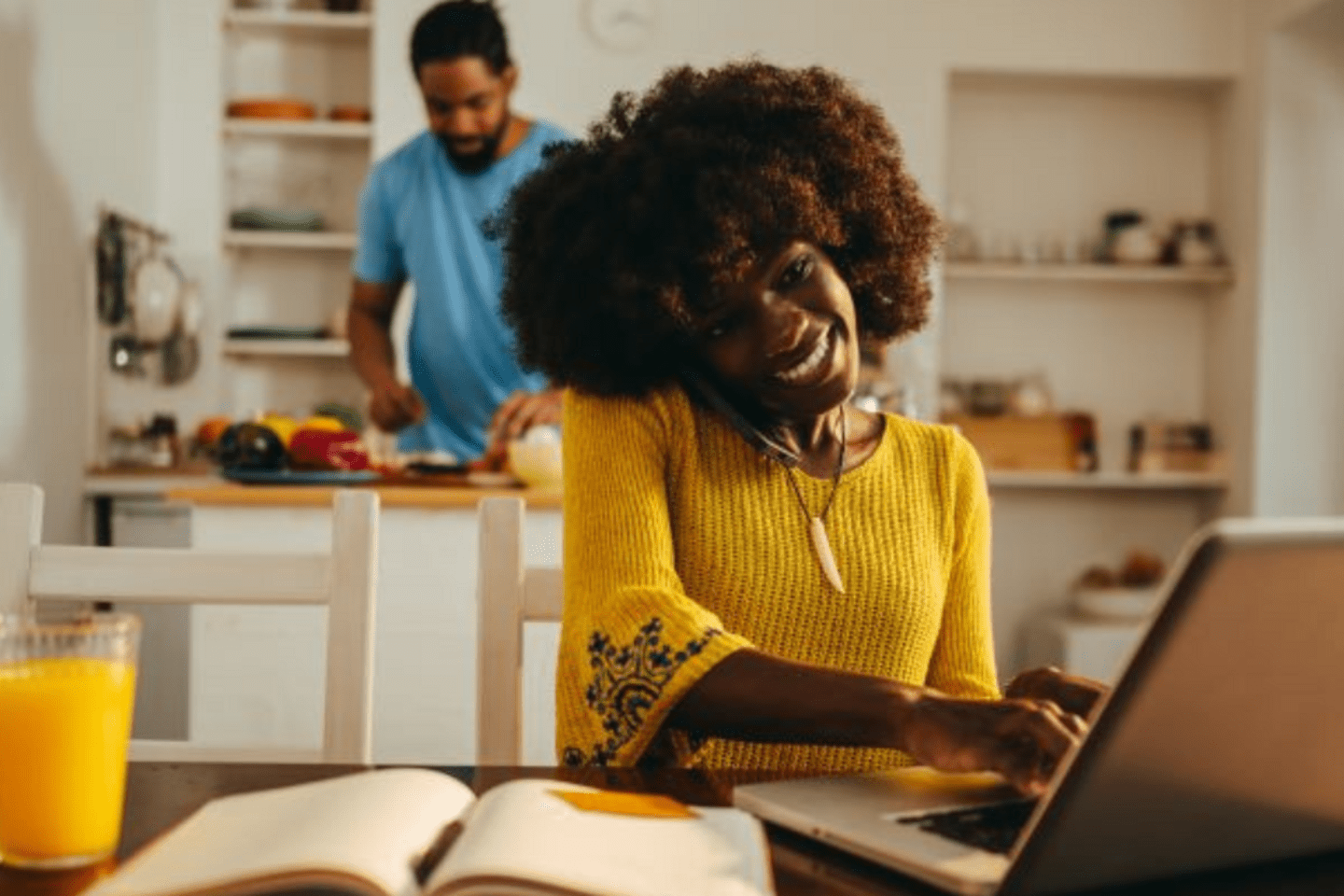 woman with yellow blouse using a laptop