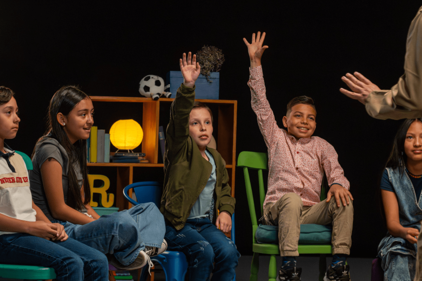 Children raising their hands in school 