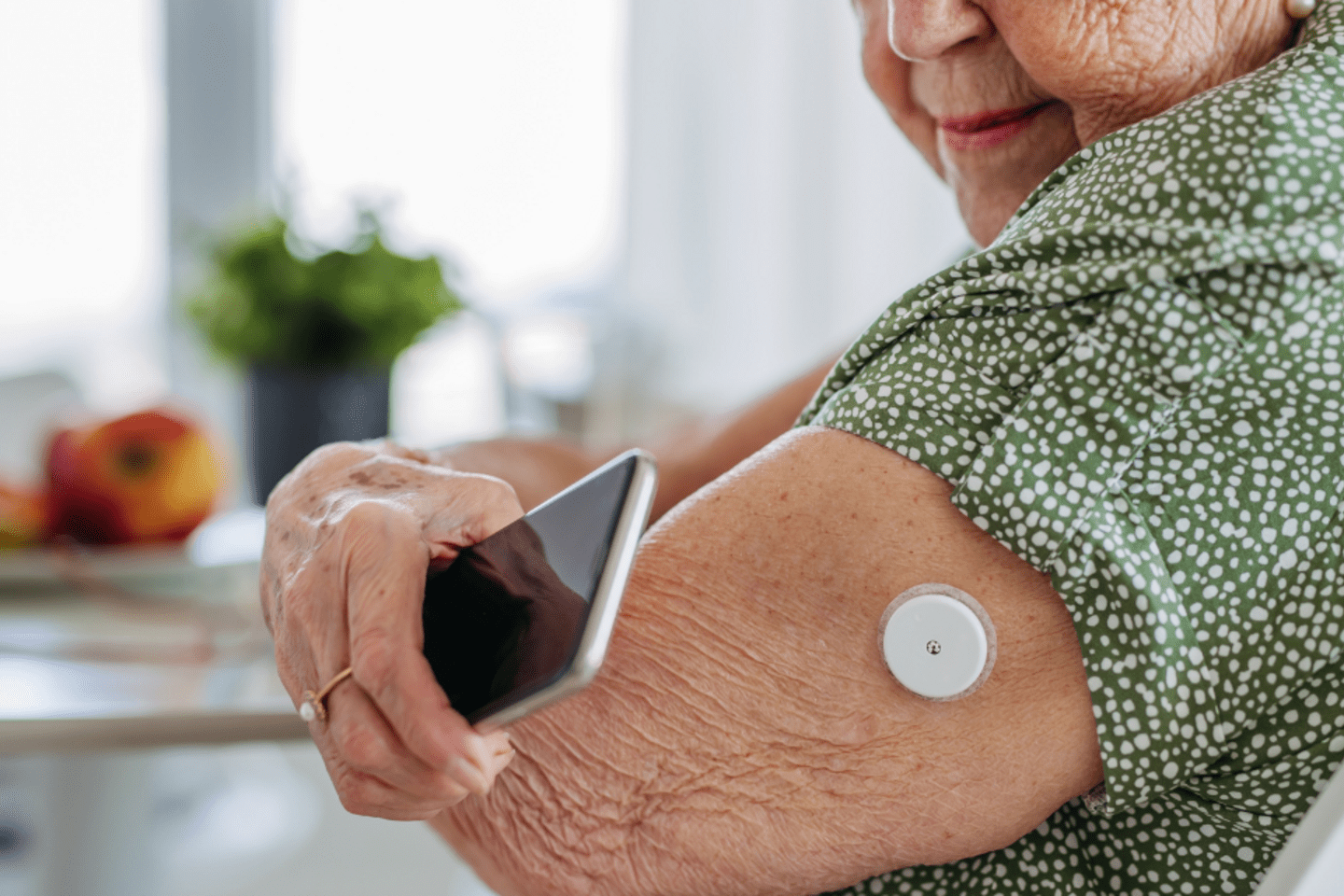 old woman checking her insulin patch 