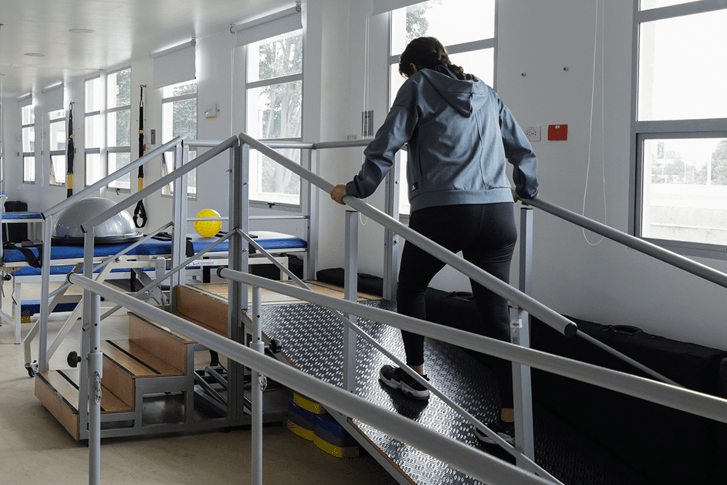 Person doing physical rehabilitation in a hospital with natural light