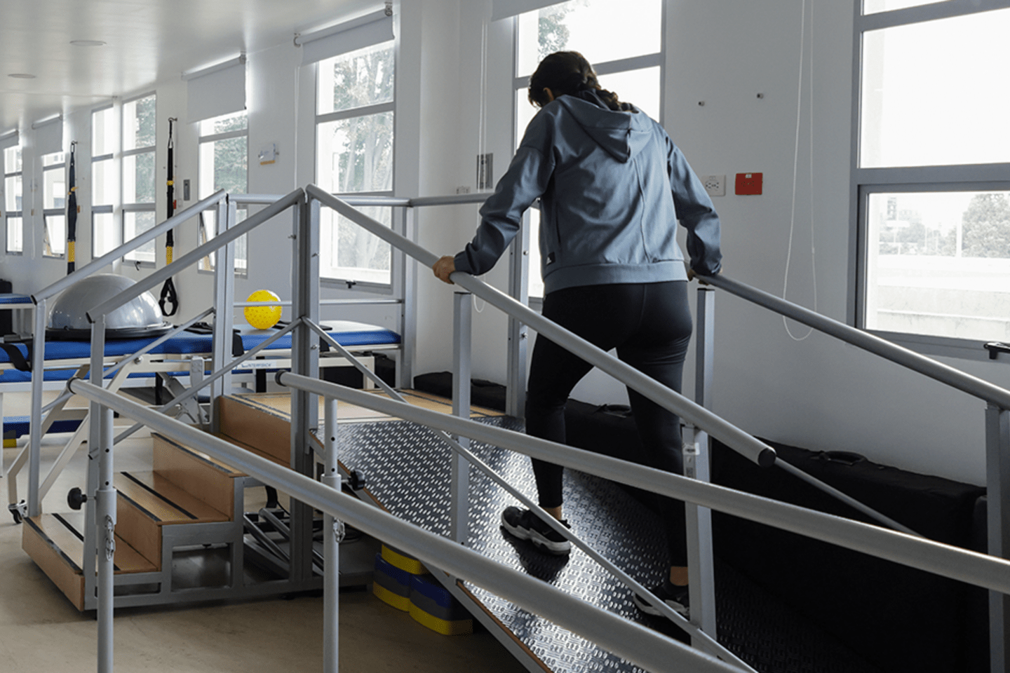 Person doing physical rehabilitation in a hospital with natural light