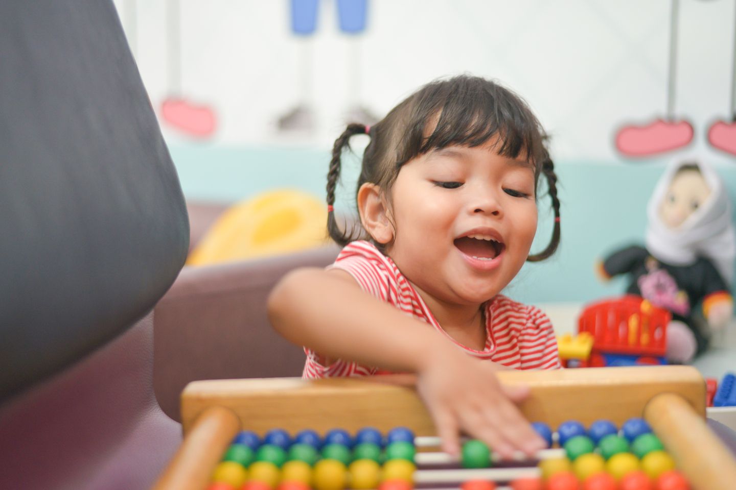 a girl is playing with am abacus