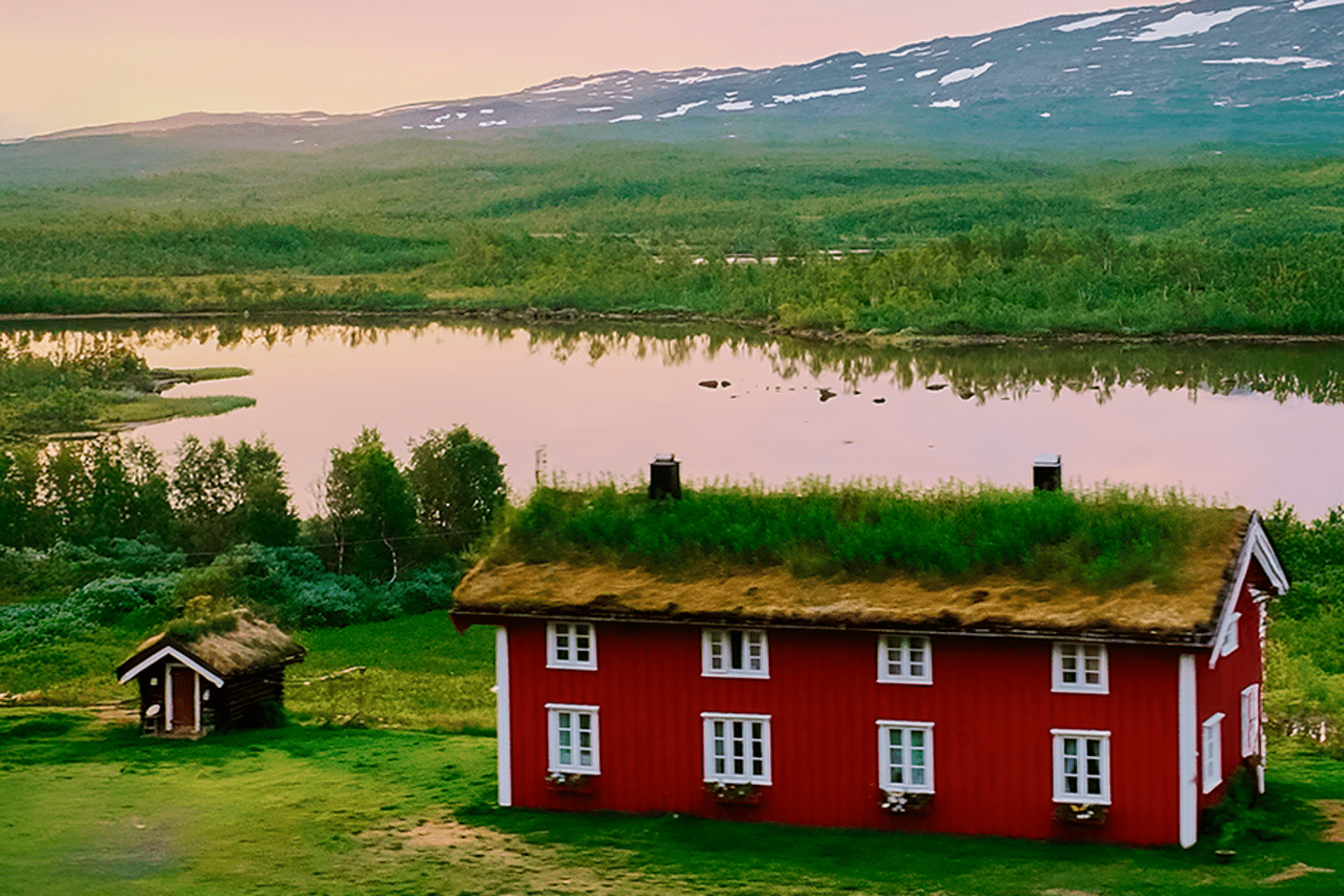 A house with grass on the roof by a river