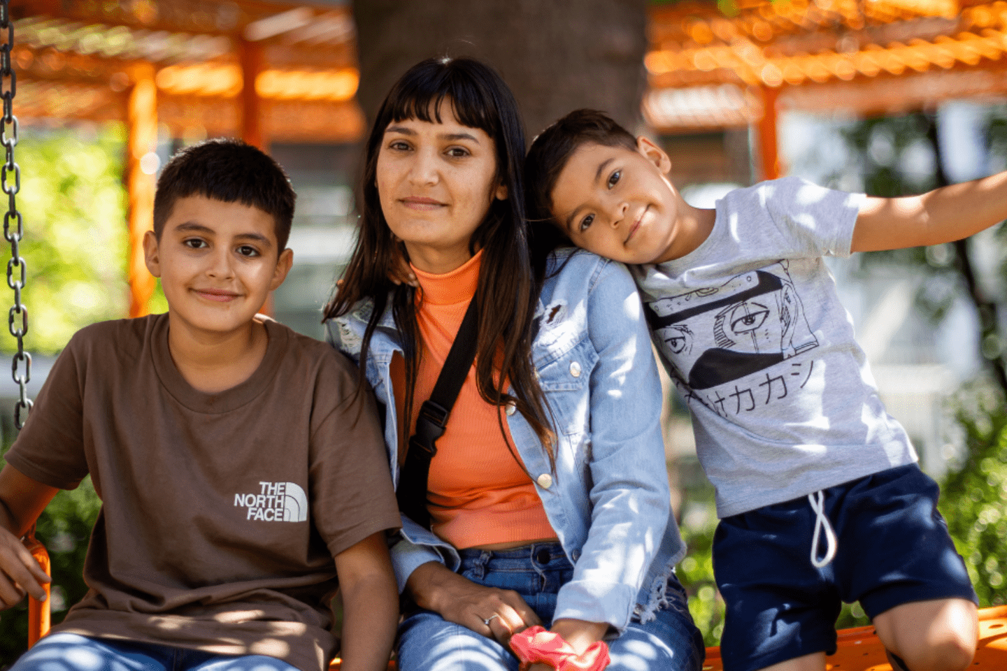 A mother with her two children at the park 