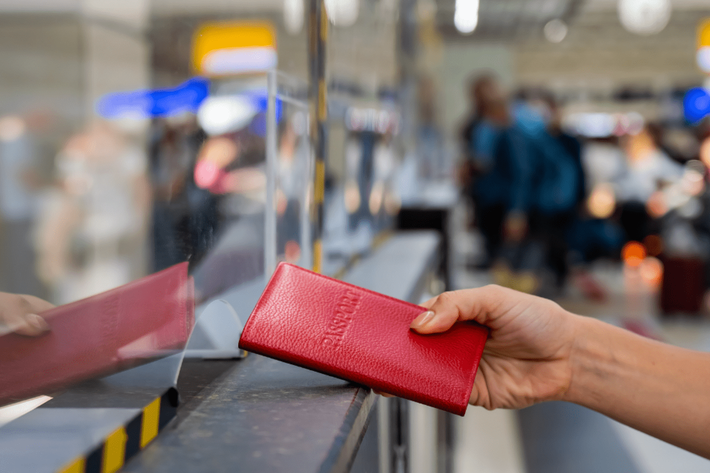 Woman hands her passport to an officer 