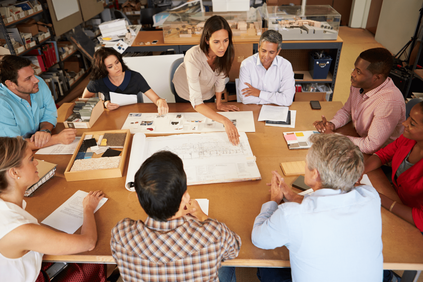 Female leading small meeting with floor plan