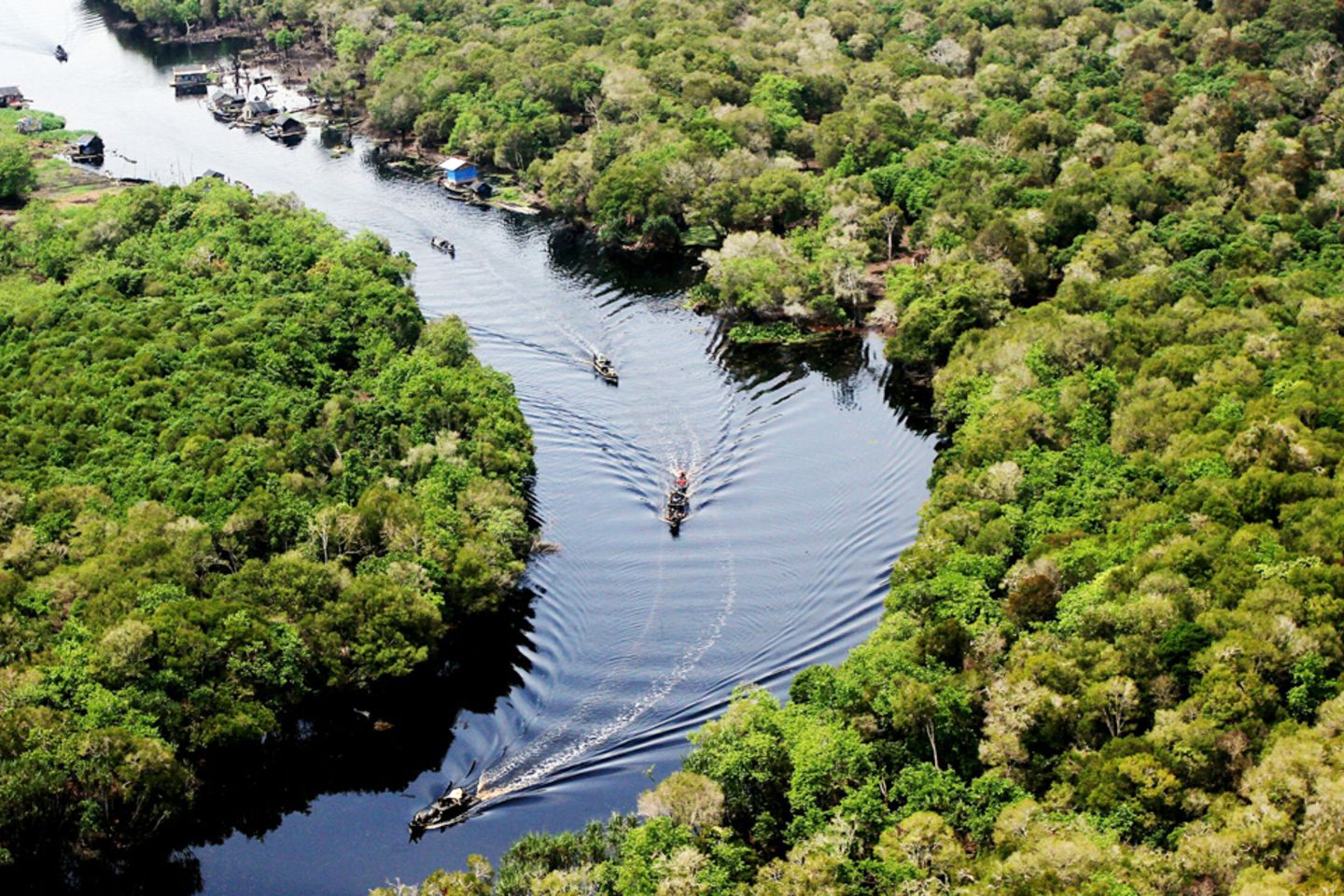 Boats navigating a river in the Amazon.