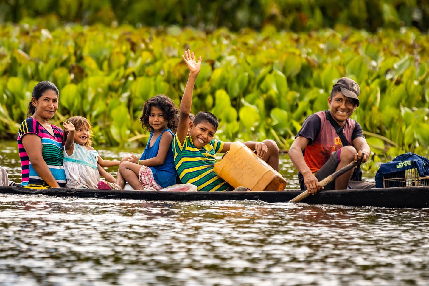 A group of people traveling by boat through the Amazon