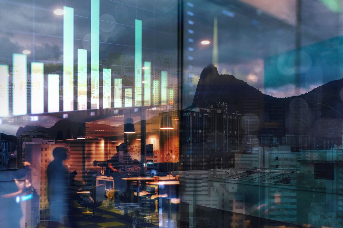 An urban view through a glass window reflecting electronic charts.
