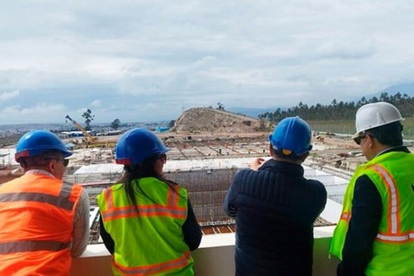 People with IDB vests looking at construction