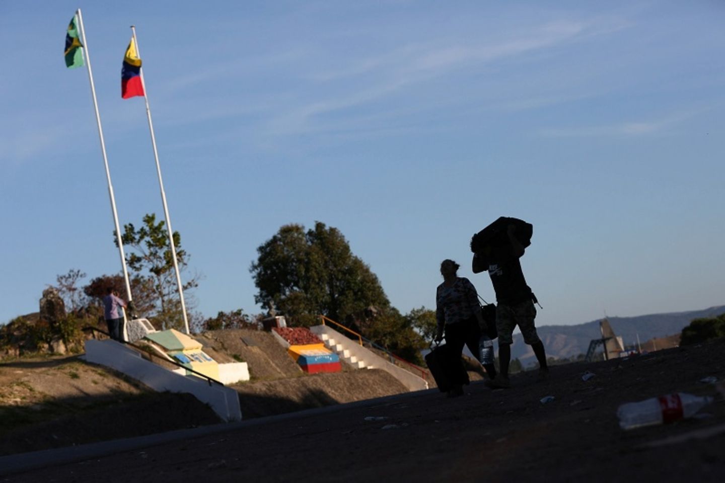 People walk at the border between Brazil and Venezuela in Pacaraima