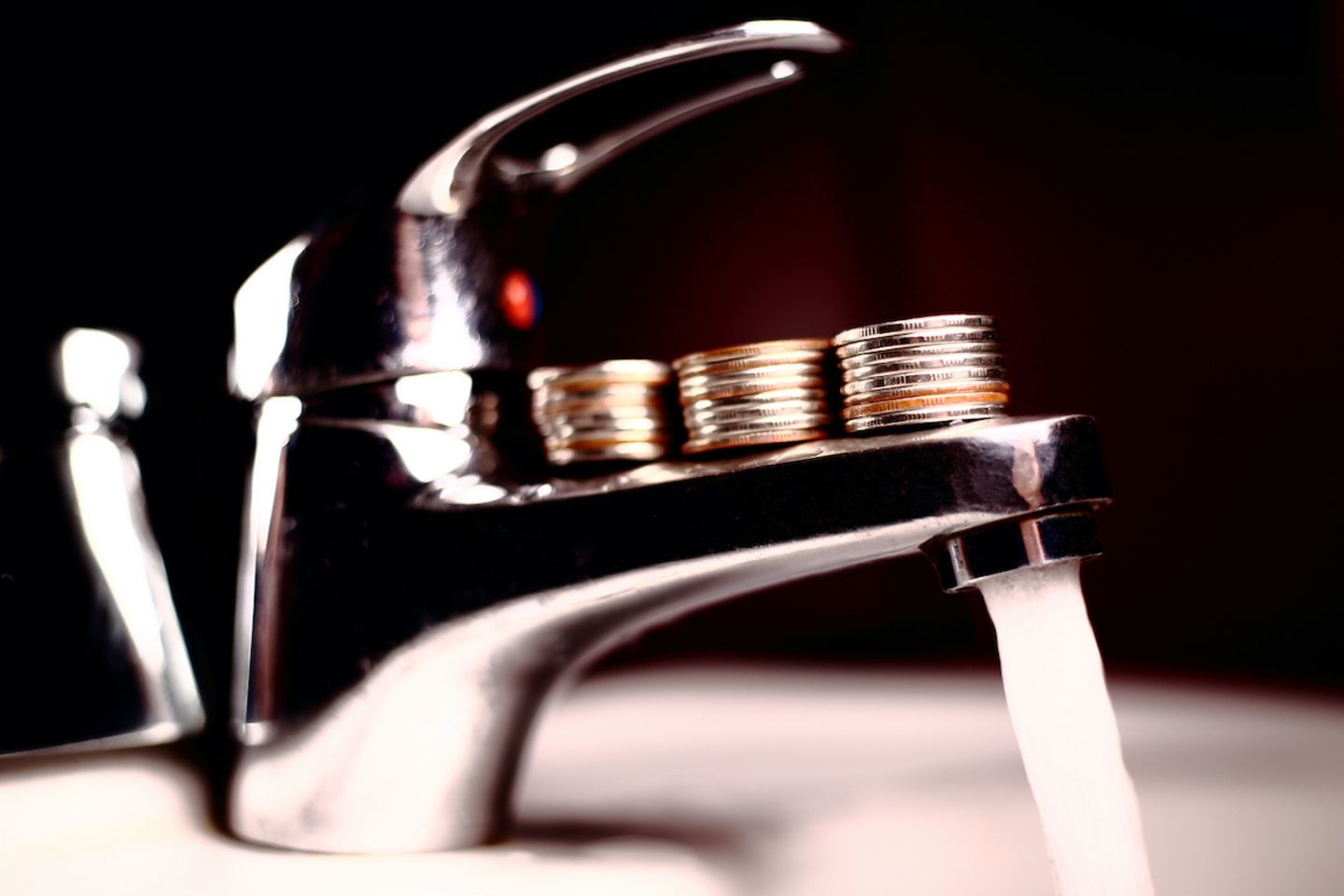 Water,Tap,On,Which,Are,Stacks,Of,Coins.,Shallow,Dof