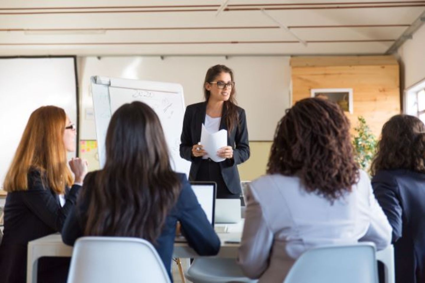 businesswomen-looking-speaker-with-papers 2